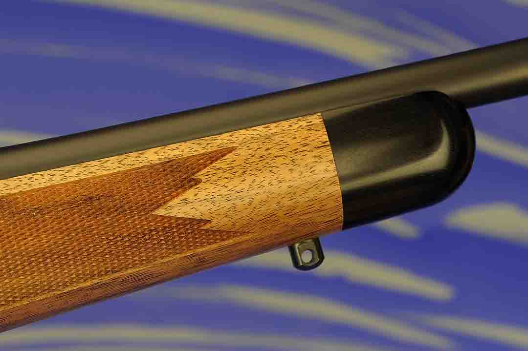 Typical of what a custom rifle is today, the ebony forend tip is cut at a 90-degree angle and attached without a white line spacer. Take note of the precise checkering pattern and the forward sling swivel stud.